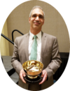 Yamil Kouri with 2019 Champion of Champions award for exhibit 
